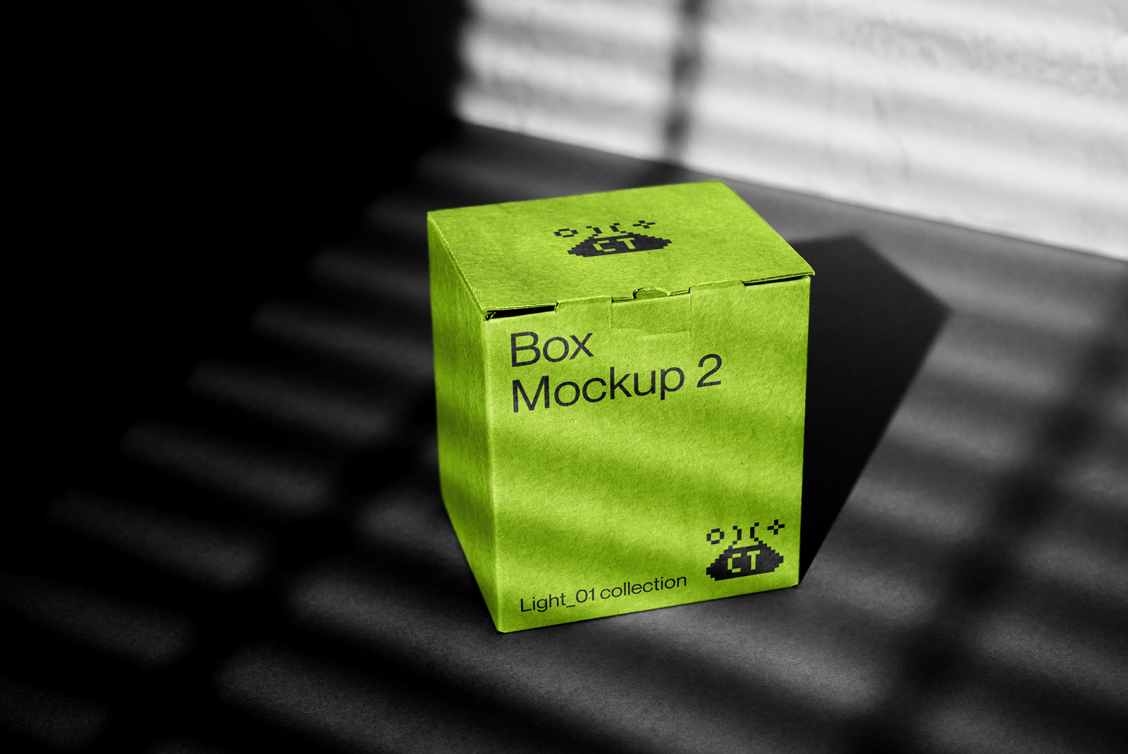 Bright green box mockup in a high contrast setting showcasing product packaging design on a flat surface with creative lighting and shadow play.